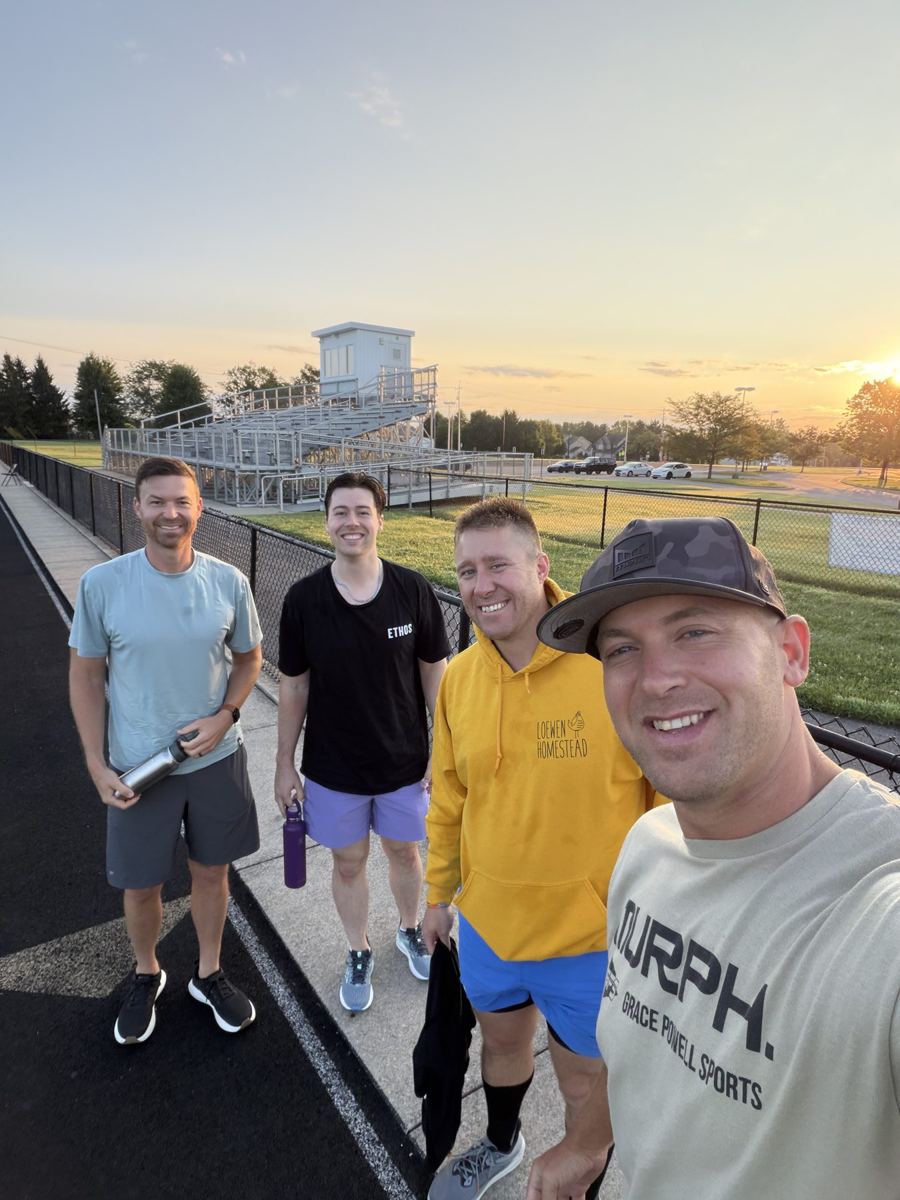Four men at the track at sunrise after a Thursday workout